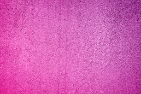 background wall with putty painted pink texture surface. Pink purple gradient