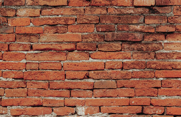 Obraz premium Red brick wall texture. Abstract brick wall background, wall of old, cracked bricks, with a weathered and faded surface. 