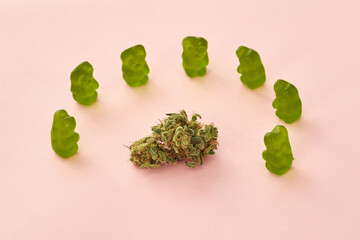 Marijuana and teddy bear candies isolated on beige