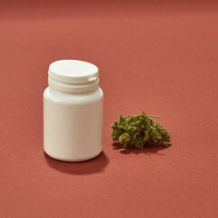 Fresh marijuana weed and jar on red background