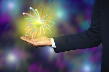 Man holding virtual model of atom on color background, closeup