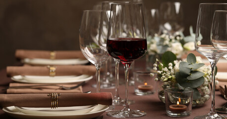 Glass of delicious wine and elegant table setting in restaurant. Banner design