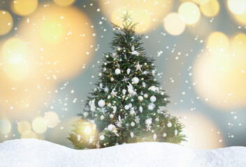 Beautifully decorated Christmas tree and snow on light background. Bokeh effect