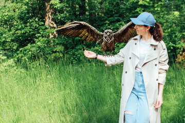 the girl holds a bird made of wooden rods on her hand