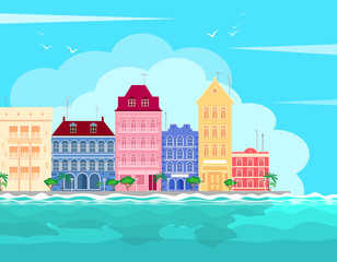Fototapeta premium Sea tropical cityscape with colorful buildings on the seafront against the backdrop of azure waves and blue sky