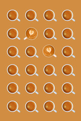Rows of Espresso Coffees with Heart Shaped Latte Art Cappuccinos on Apricot Brown Background