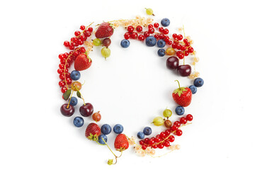 Various fresh summer berries round frame on white background. Top view