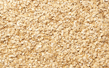 close-up texture of raw dry rolled oats top view.