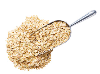 metal spoon or scoop with raw dry rolled oats isolated on white background top view.