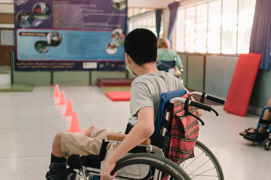 Young man with disability practicing wheelchair by an occupational therapist teacher on ramps for people with disabilities,Lifestyle in the education age and practicing essential skills in daily life.