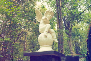 Angel in the cemetery monument at the grave of a child sculpture in the form of an angel