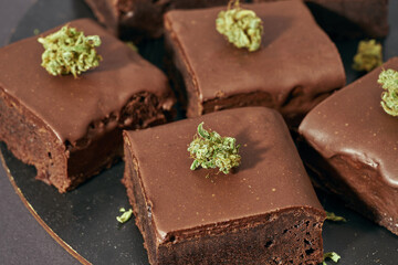 Partial of sweet cake pieces and marijuana buds