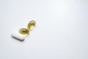 Pill close-up on a white background in a hand. Taking vitamins or medications. The concept of healthcare, medicine, pharmacies, disease prevention