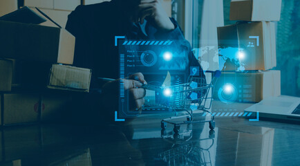 Woman start up small business owner writing address on cardboard box at workplace.small business entrepreneur SME or freelance asian woman working with box at home.