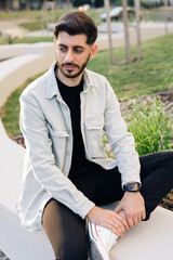 Gorgeous face of young bearded mixed-race elegant man with brown eyes. Beautiful caucasian european man looking stright outdoors. Outdoor relax. Happy relax. Male portraits.