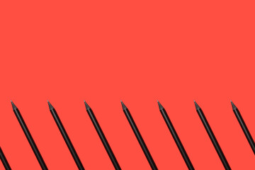 black pencils on a red background geometric pattern