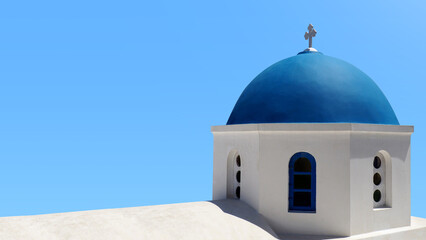 Closeup of Santorini blue chapel dome on light blue sky