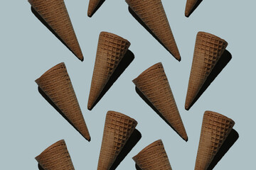 many empty ice cream cones on a blue background