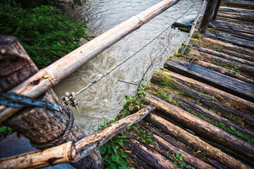 photo of an old bridge over a mountain stream