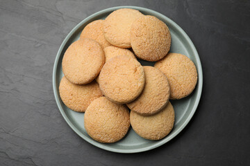 Delicious sugar cookies on black table, top view