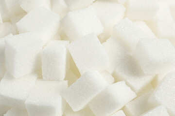 White sugar cubes as background, closeup view