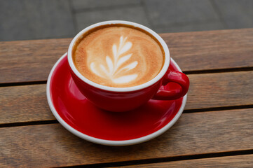 Cup of aromatic coffee on wooden table, closeup