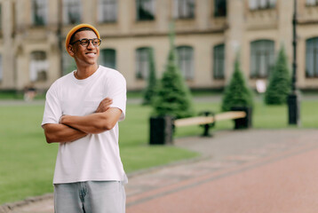 A portrait of an African American Stylish Trendy student with glasses smiling with the university...