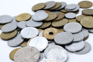 scaterred pesetas spanish old coins on white background