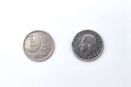 five punds old coins on white background