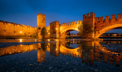 Castelvecchio Bridge over the Adige River in Verona, Italy at twilight.