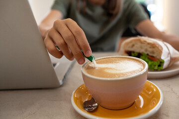 close-up of female hand holding a cup of coffee