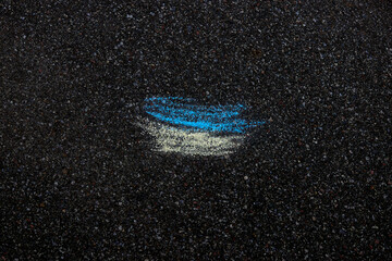 The flag of Ukraine is drawn in chalk on the asphalt. High quality photo