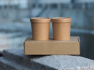Stack of cardboard delivery boxes. Delivery box and two cardboard containers stands on the concrete table, front view. Delivery, shopping, business concept.