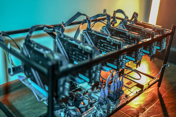 Close up of cryptocurrency mining rig and computer graphics