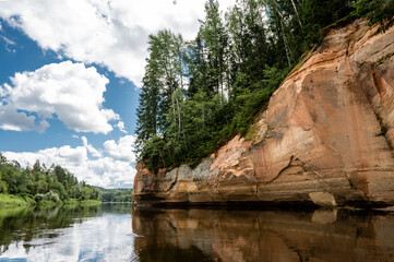 Scenic landscape of river Gauja. Sandy rocks on the shore. Summer nature in Latvia.