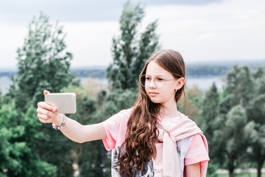 A Serious Girl In Glasses Takes A Video Selfie On A Smartphone. Content For Social Networks