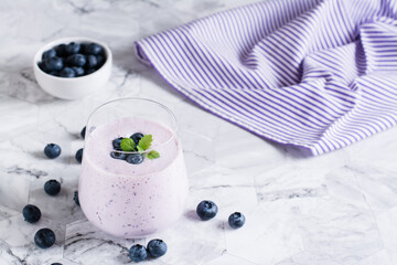 A glass of blueberry smoothie on the table. Antioxidant organic healthy food