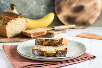Pieces of banana bread on a plate on the table. Homemade breakfast