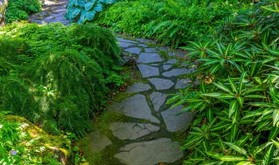 A stone paved path winds through the Abkhazi gardens in Victoria British Columbia Canada