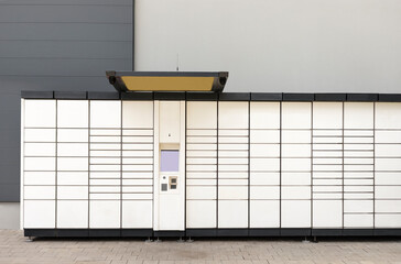 Pickup station - logistical point, automat terminal for depositing items (shipments), is a modern parcel locker with many postal boxes. Self service, contactless pack delivery. Horizontal plane. 