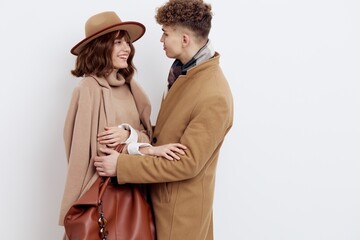 a happy couple is standing in autumn , stylish clothes and no need to hug each other looking at each other