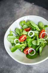 salad vegetable tomato, onion, lettuce mix, mache green fresh healthy meal food snack diet on the table copy space food background rustic top view 