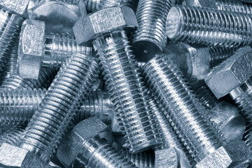 Many metal bolts as background