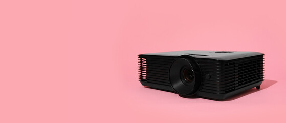 Video projector on pink background with space for text
