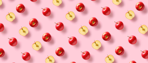 Ripe fresh apples on pink background. Pattern for design