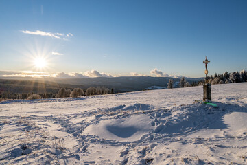 Cross and sun on Zhuri at winter, Sumava national park, Czech republic 