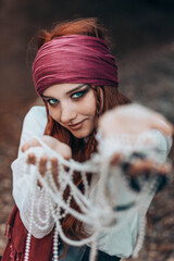 Outdoor close-up portrait of young female in pirate costume