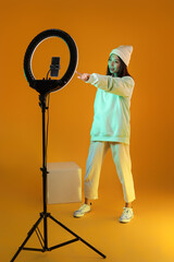 Female Asian blogger recording video in studio