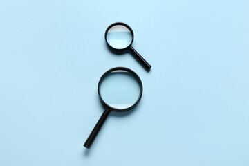 Magnifying glasses on light blue background