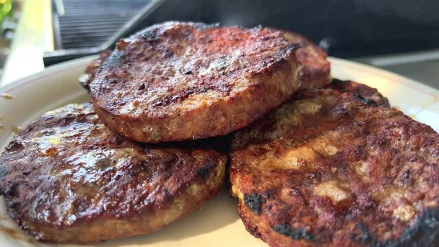Meat steak for burger type cutlets spread on a plate pass it fried on fire Here is also a video. High quality 4k footage